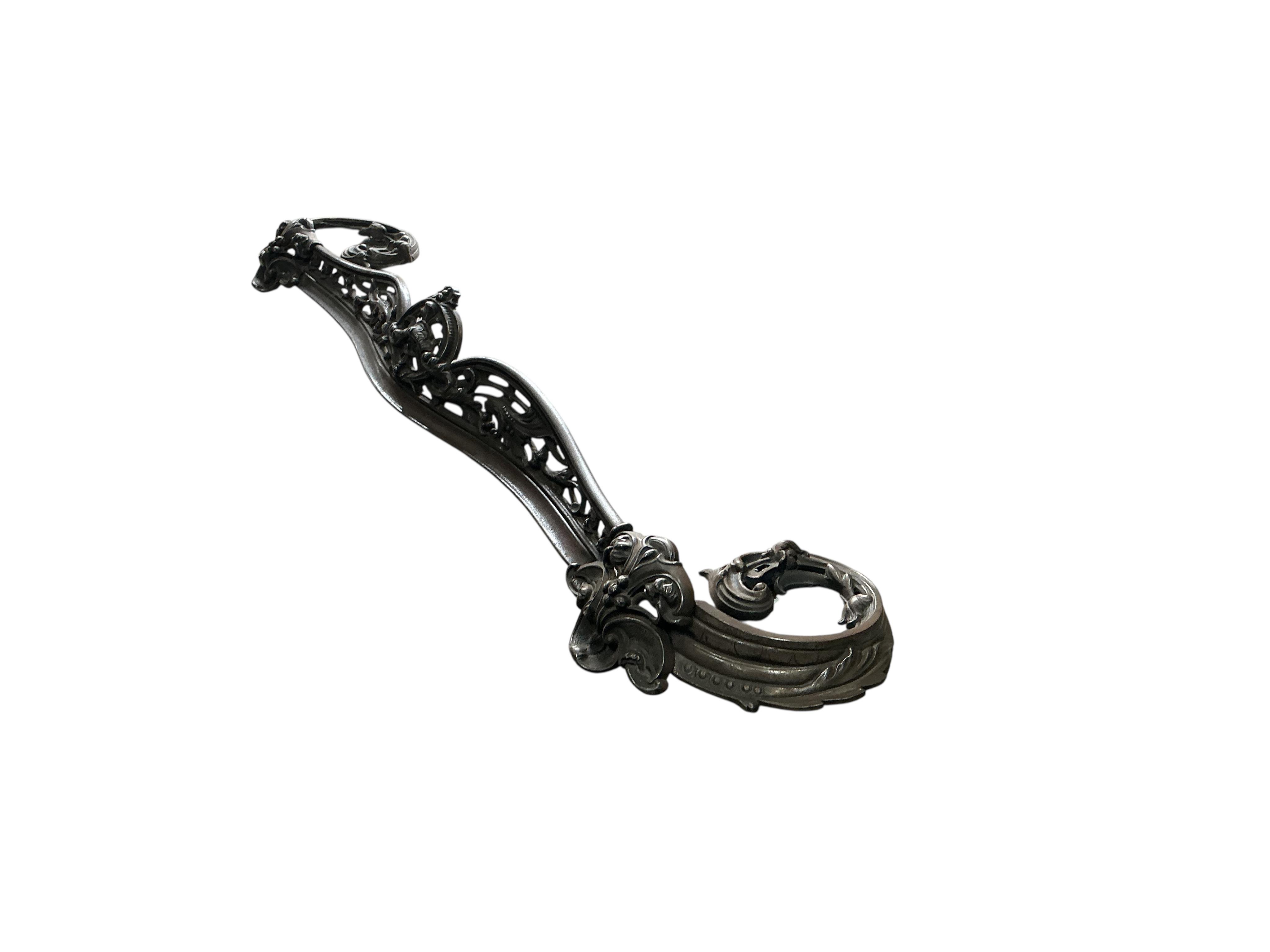 A Victorian polished steel serpentine fender, width 144cm